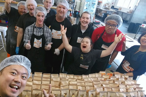 Photo of staff at The Cookie Project with bags of biscuits